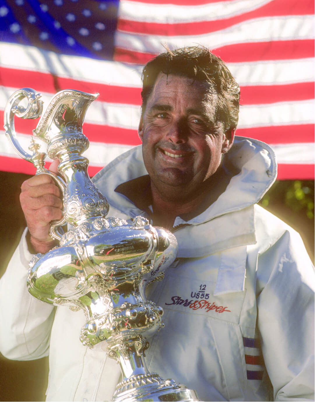 Dennis Conner holding the America's Cup trophy
